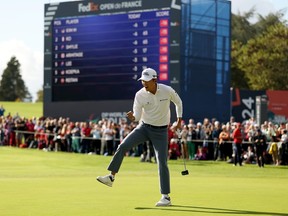 Michael Kim of the United States celebrates holing a par putt.
