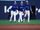 From left, Myles Straw #3, Daulton Varsho #5, and Nathan Lukes #38 celebrate in the outfield at the end of their MLB game against the Boston Red Sox at Rogers Centre on September 25, 2025 in Toronto, Ontario, Canada.