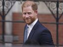 FILE - Britain's Prince Harry smiles towards the media as he leaves the Royal Courts of Justice in London, Tuesday, April 8, 2025.