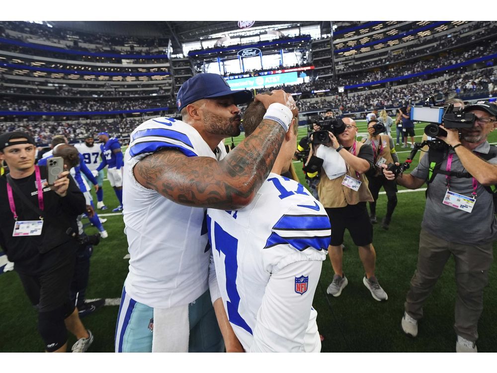 Dallas Cowboys quarterback Dak Prescott (4) gives place kicker Brandon Aubrey, right, a kiss on the head after the team's overtime win in an NFL football game against the New York Giants Sunday, Sept. 14, 2025, in Arlington, Texas.