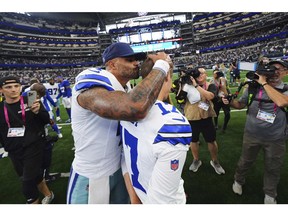 Dallas Cowboys quarterback Dak Prescott (4) gives place kicker Brandon Aubrey, right, a kiss on the head after the team's overtime win in an NFL football game against the New York Giants Sunday, Sept. 14, 2025, in Arlington, Texas.