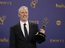 Jon Stewart poses in the press room with the award for outstanding talk series for