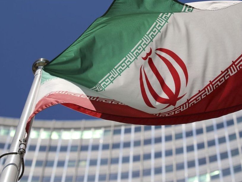 FILE - The Iranian flag flies in front of a U.N. building where closed-door nuclear talks take place at the International Center in Vienna, Austria, on June 18, 2014.