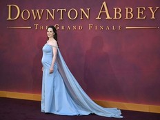 A pregnant Michelle Dockery poses on the red carpet at the world premiere of the film "Downton Abbey: The Grand Finale" in London.