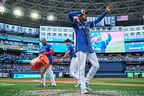 Blue Jays pitcher Kevin Gausman reacts after being doused by teammates Vladimir Guerrero Jr. and Joey Loperfido after their win against the Houston Astros in Toronto, on Thursday, Sept. 11, 2025.