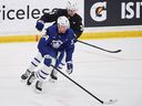 Maple Leafs forward Auston Matthews tries to pull away from new defenceman Henry Thrun during the opening week of training camp.