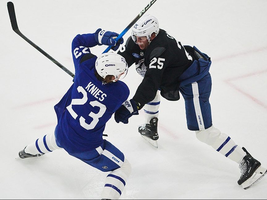 Maple Leafs defenceman Brandon Carlo (right), here trying to keep Matthew Knies from getting to a loose puck during training camp, saw the potential for off-ice distractions with the Bruins last season. 