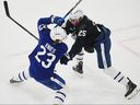 Maple Leafs defenceman Brandon Carlo (right), here trying to keep Matthew Knies from getting to a loose puck during training camp, saw the potential for off-ice distractions with the Bruins last season.