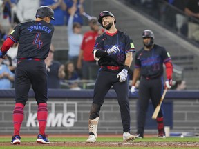 Blue Jays' Nathan Lukes (right) celebrates with George Springer after hitting a two-run home run off Tampa Bay Rays pitcher Adrian Houser during the fifth inning in Toronto on Friday, Sept. 26, 2025.