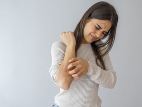 Woman scratching an itch.