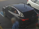 A screenshot from a video released by Toronto police showing a woman in a vehicle engaged in a distracted theft.