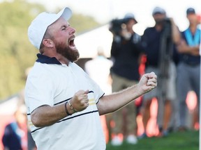 Shane Lowry of Team Europe makes his putt to retain Ryder Cup