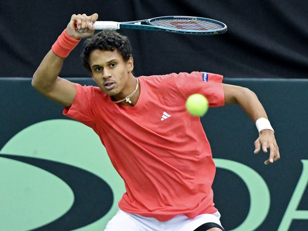 Gabriel Diallo, of Canada, plays a shot to Fabian Marozsan, of Hungary, during their Davis Cup qualifying tennis match in Montreal on Sunday, February 2, 2025.  