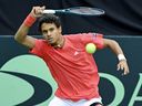 Gabriel Diallo, of Canada, plays a shot to Fabian Marozsan, of Hungary, during their Davis Cup qualifying tennis match in Montreal on Sunday, February 2, 2025.