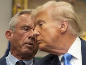 Robert F. Kennedy Jr. speaks as Donald Trump listens.