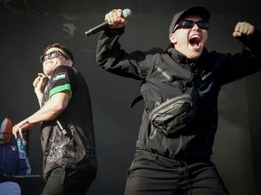 Naoise O Caireallain (C), aka Moglai Bap, and Liam O’Hanna (R), aka Mo Chara, perform in Paris. (Guillaume BAPTISTE/AFP)