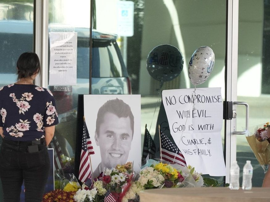 Well-wishers pay their respects at a makeshift memorial at the national headquarters of Turning Point USA shown after the shooting death of Charlie Kirk, the co-founder and CEO of the organization, during a Utah college event Wednesday, Sept. 10, 2025, in Phoenix.