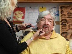 A makeup artist works on Graham Greene on the set of the TV show “Caution: May Contain Nuts” in Edmonton on June 3, 2011.