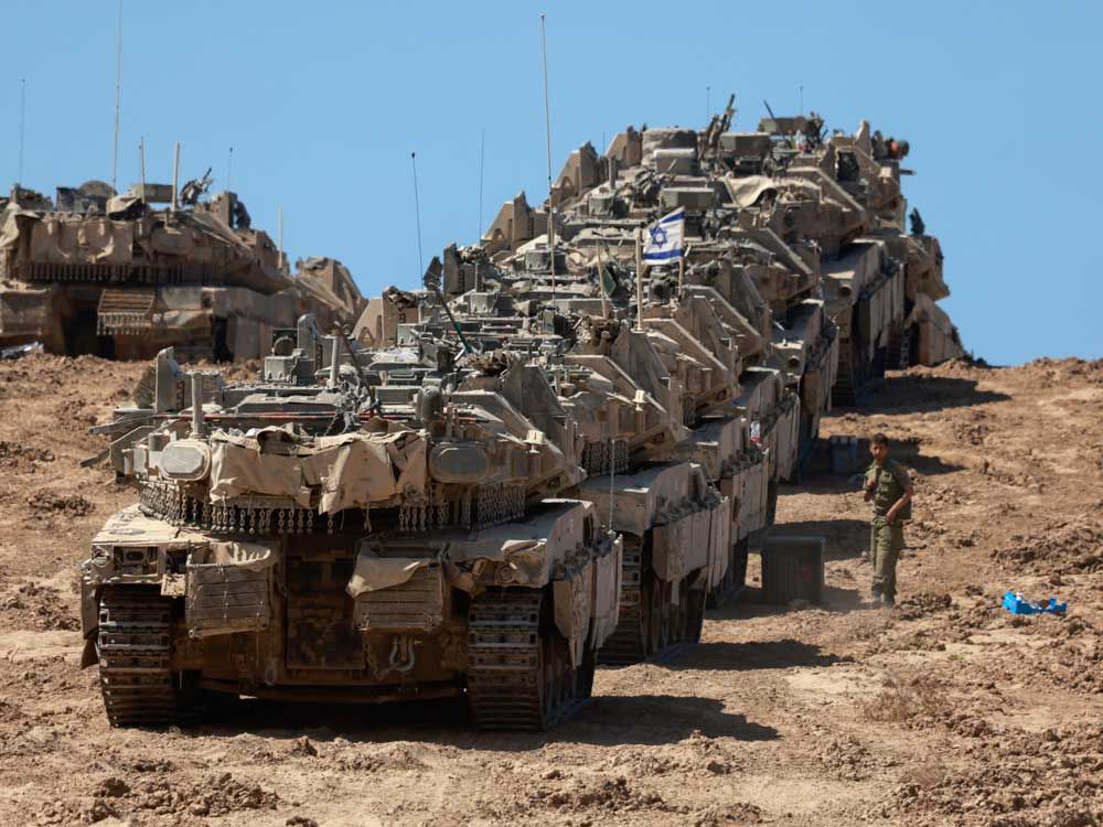 A convoy of Israeli tanks is deployed at Israel's border with the Gaza Strip on Sept. 16, 2025.