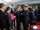 This photograph taken on Sept. 2, 2025 and released by North Korea's official Korean Central News Agency (KCNA) via KNS shows North Korea's leader Kim Jong Un (second from right) and his daughter Kim Ju Ae (right) being greeted by China's Foreign Minister Wang Yi (centre left) upon their arrival at the Beijing Railway Station in Beijing.