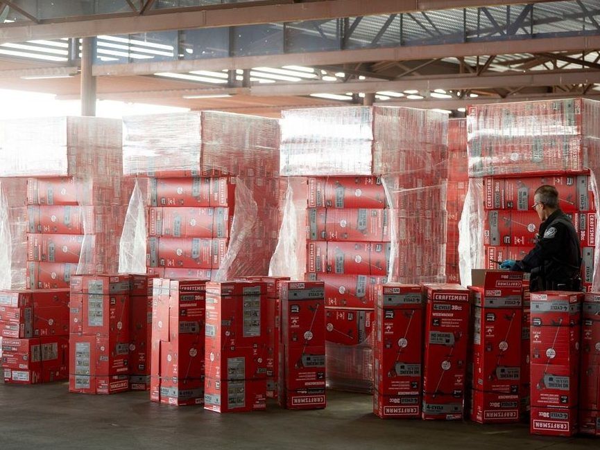 A U.S. Customs and Border Protection agent inspects boxes of tools at a port of entry in Nogales, Ariz. 