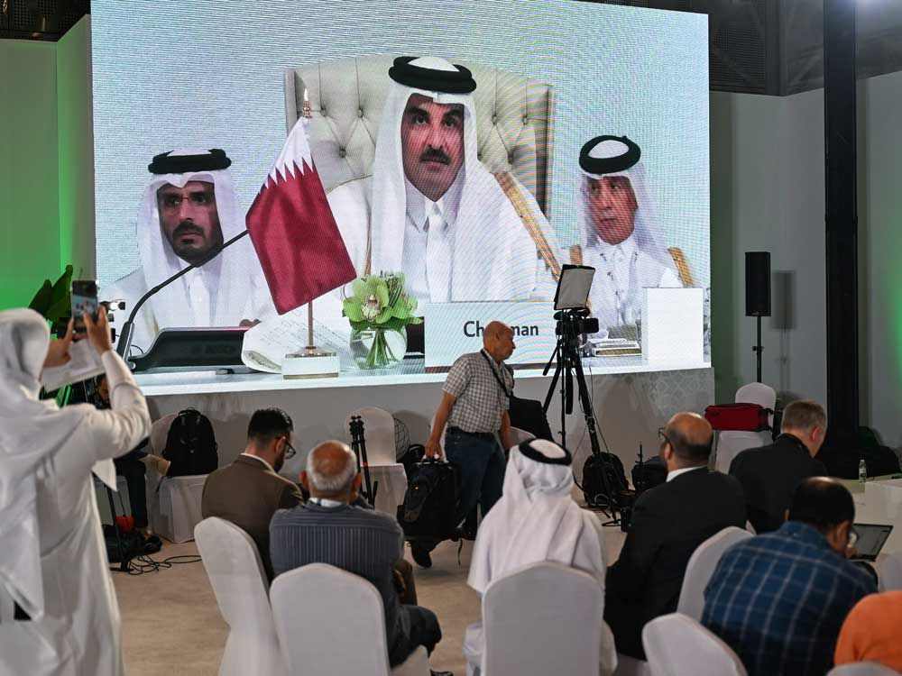 Reporters follow Qatar's Emir Sheikh Tamim bin Hamad Al-Thani's address at the media centre, during the opening of the 2025 ArabIslamic emergency summit in Doha on Sept. 15, 2025.