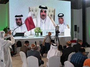 Reporters follow Qatar's Emir Sheikh Tamim bin Hamad Al-Thani's address at the media centre, during the opening of the 2025 ArabIslamic emergency summit in Doha on Sept. 15, 2025.