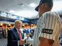 U.S. President Donald Trump shakes hands with New York Yankees Aaron Judge in their locker room before a baseball game against the Detroit Tigers, Thursday, Sept. 11, 2025, in New York.