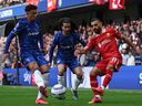 Liverpool's Mohamed Salah (R) crosses the ball during a Premier League match against Chelsea last season.