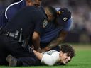 Stadium security tackles a spectator who ran onto the field during the fourth inning between the New York Yankees and the Toronto Blue Jays in ALDS Game 3.
