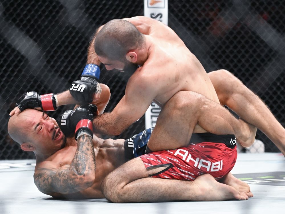 Aiemann Zahabi (top) punches Jose Aldo during their featherweight bout at UFC 315 on May 10, 2025.