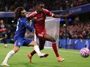 Alexander Isak of Liverpool is challenged by Marc Cucurella of Chelsea during their Premier League match.