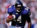 Jay Graham of the Baltimore Ravens carries a football during a game in 1997.