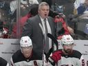 New Jersey Devils head coach Sheldon Keefe watches his players on the bench during a game earlier this year.