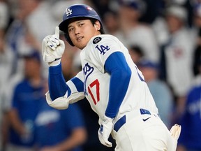 Shohei Ohtani of the Los Angeles Dodgers celebrates a home run against the Milwaukee Brewers during the NLCS.