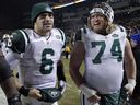 New York Jets quarterback Mark Sanchez (left) walks off the field with center Nick Mangold after an NFL game in 2010.