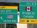 A sign on Interstate 75 directs motorists to Detroit or Canada, near the Ambassador Bridge in Detroit, Michigan, August 1, 2025.