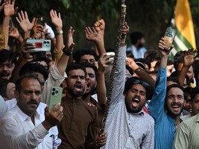 Activists shout slogans during a demonstration in Muzaffarabada.