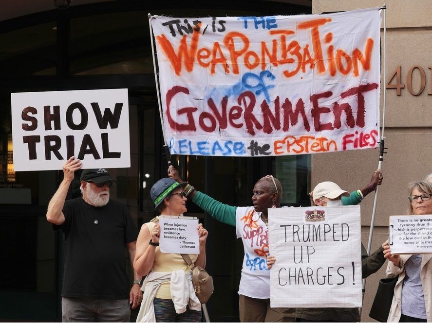 Activists protest outside the Bryan U.S. District Court for the Eastern District of Virginia during the arraignment of former FBI Director James Comey on October 8, 2025 in Alexandria, Virginia. Comey will go on trial today after a Virginia grand jury indicted him on charges of making false statements and obstructing congressional testimony in 2020.