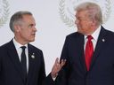 US President Donald Trump (right) greets Prime Minister Mark Carney during the Gaza summit in Sharm el-Sheikh on October 13, 2025.