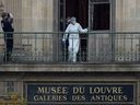 A French forensic expert examines the cut window and balcony of the Louvre gallery, which was the scene of a robbery at the world famous museum in Paris, France earlier that day, October 19, 2025.