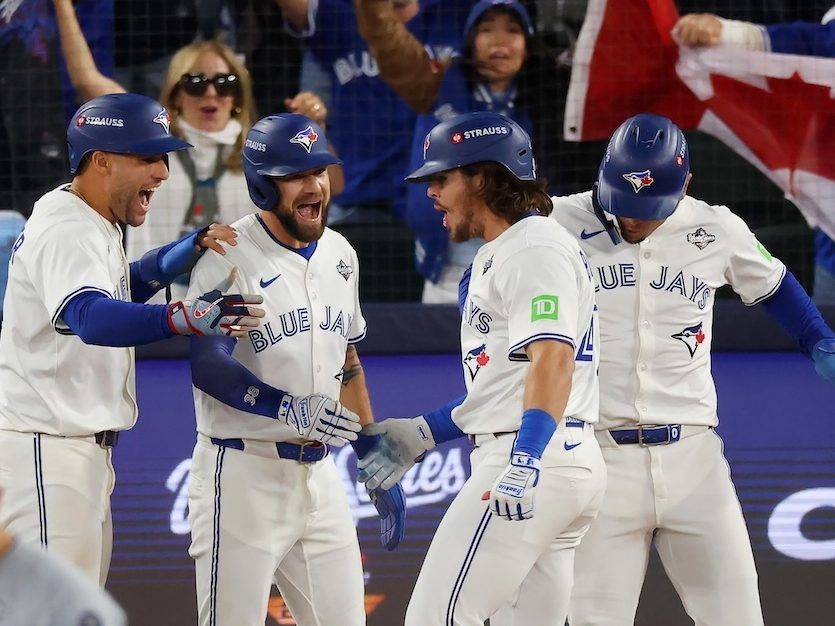 Addison Barger #47 of the Toronto Blue Jays is welcomed home after hitting a grand slam home run against the Los Angeles Dodgers during the sixth inning of Game 1 of the 2025 World Series at Rogers Center on October 24, 2025 in Toronto. 