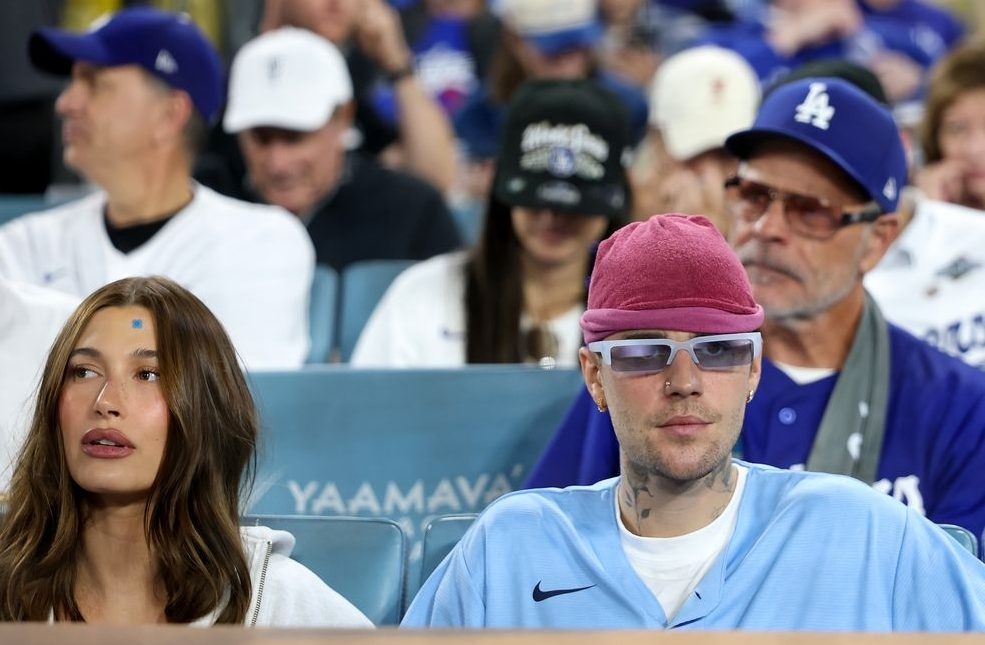 Justin Bieber and Hailey Bieber watch game three of the 2025 World Series between the Toronto Blue Jays and the Los Angeles Dodgers at Dodger Stadium on October 27, 2025 in Los Angeles.  Justin Bieber and Hailey Bieber watch game three of the 2025 World Series between the Toronto Blue Jays and the Los Angeles Dodgers at Dodger Stadium on October 27, 2025 in Los Angeles.