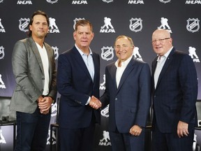 File - From left, Ron Hainsey, NHLPA assistant executive director, Marty Walsh, NHLPA executive director, Gary Bettman, NHL commissioner and Bill Daly, NHL deputy commissioner, pose for photos after a joint press conference ahead of the NHL Hockey Project, June 27, 2025 in Los Angeles.