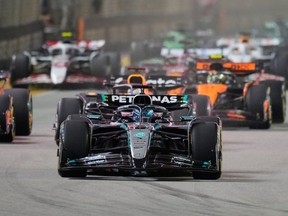 Mercedes driver George Russell from Britain heads the field after the start during the Grand Singapore Formula -1 on Marina Bay Street in Singapore, Sunday, October 5, 2025.