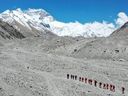 FILE - In this May 16, 2020 aerial photo released by Xinhua News Agency, Chinese surveyors hike toward a higher spot from the base camp on Mount Qomolangma at an altitude of 5,200 meters.