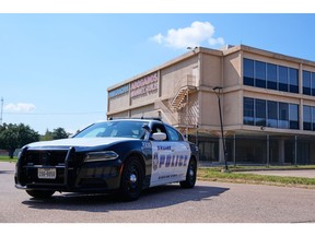 A Dallas police officer's vehicle blocks the road near a crime scene near the U.S. Immigration and Customs Enforcement office Thursday, Sept. 25, 2025, in Dallas.