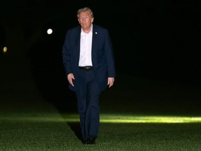 President Donald Trump walks across the South Lawn of the White House, early Tuesday, Oct. 14, 2025, in Washington, after returning from a trip to Israel and Egypt.