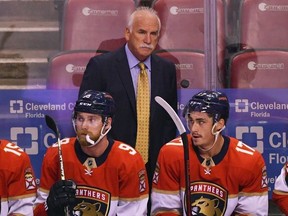 FILE - Florida Panthers head coach Joel Quenneville, center, looks on from the bench during the first period of an NHL hockey game against the Colorado Avalanche, Oct. 21, 2021, in Sunrise, Florida.