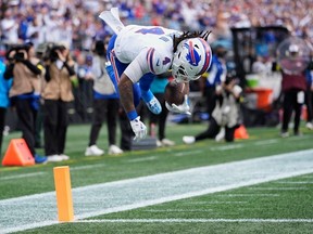 Buffalo Bills running back James Cook III (4) jumps into the end zone for a touchdown against the Carolina Panthers during the first half an NFL football game, Sunday, Oct. 26, 2025, in Charlotte, N.C.